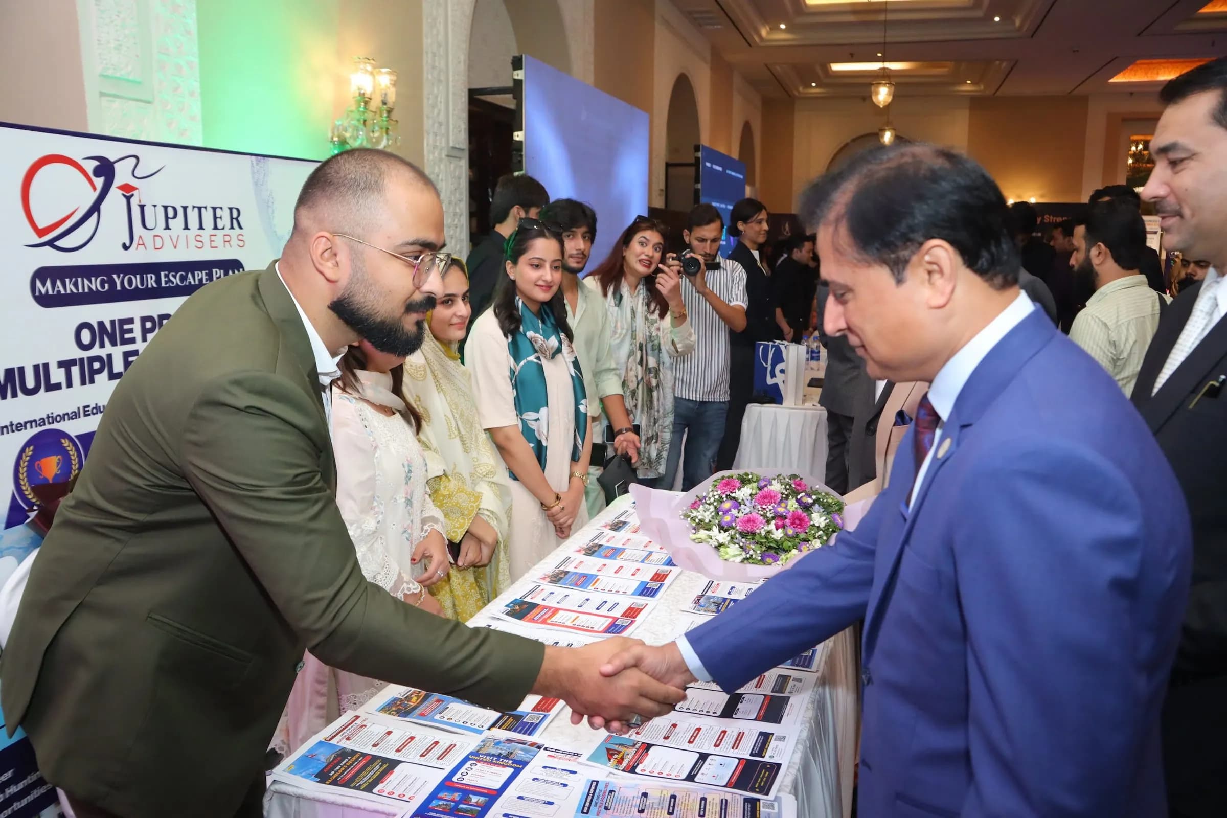 An exhibitor shaking hands with a guest at their stand at PBLS Serena Islamabad