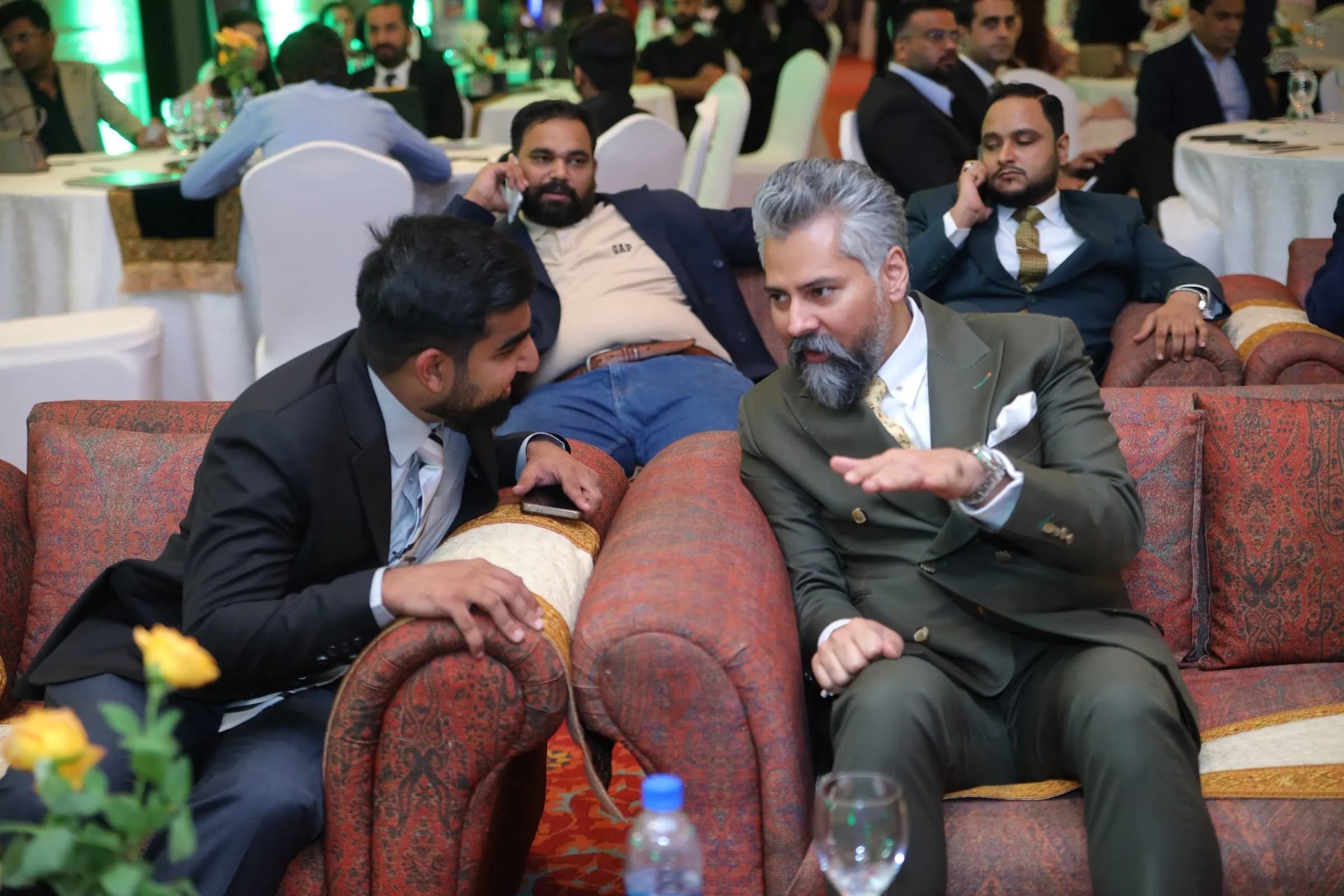 Two executives deep in conversation in the lounge seating at PBLS Serena Islamabad