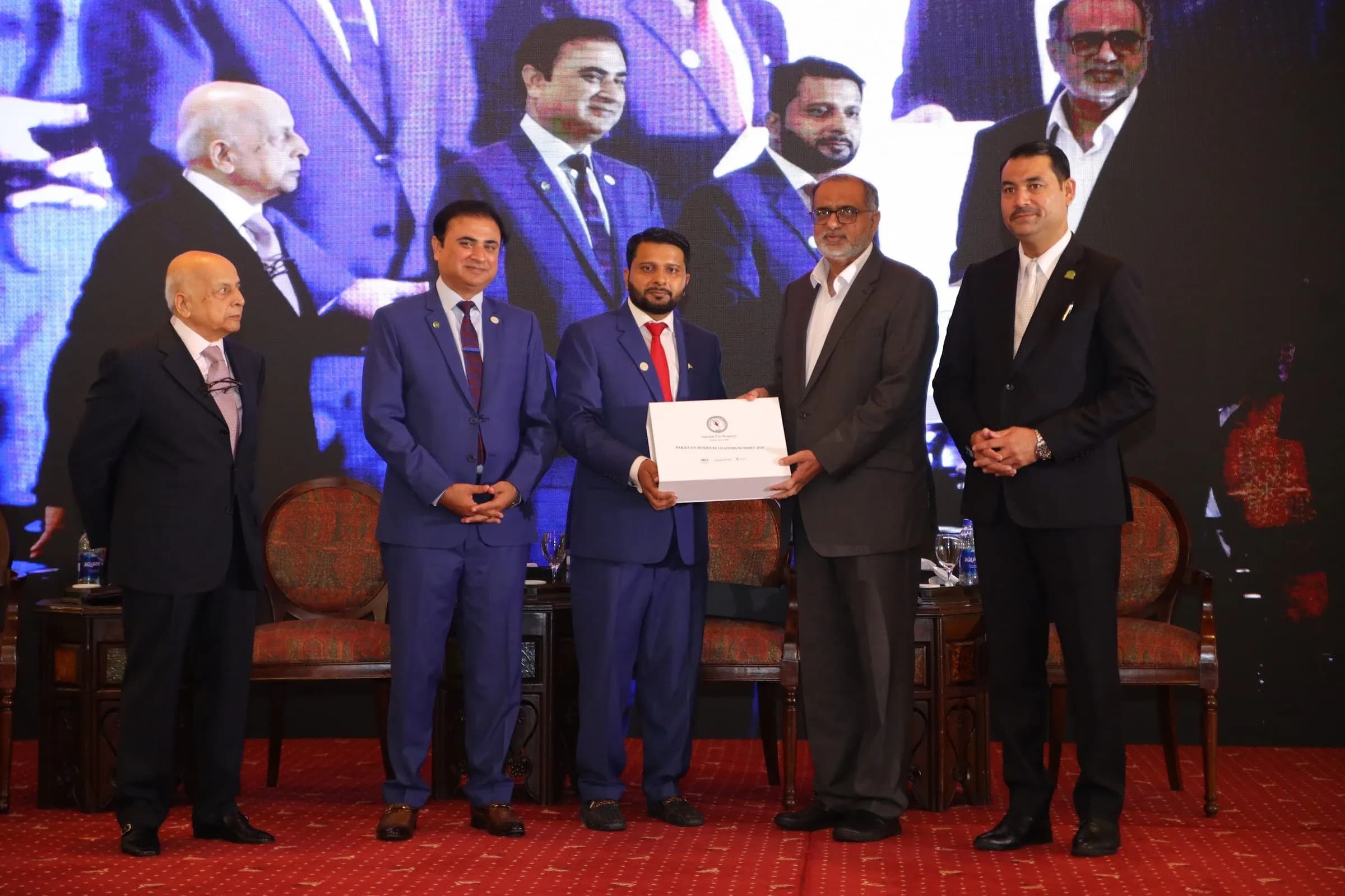 A certificate presented to a guest on stage at PBLS Serena Islamabad